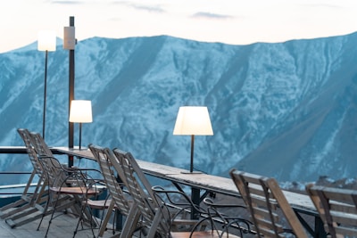 Panoramic shot of the café’s outdoor seating area overlooking the majestic Hunza mountains at sunset.