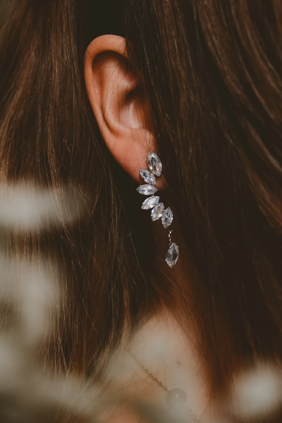 Close-up of an ear with stacked earrings