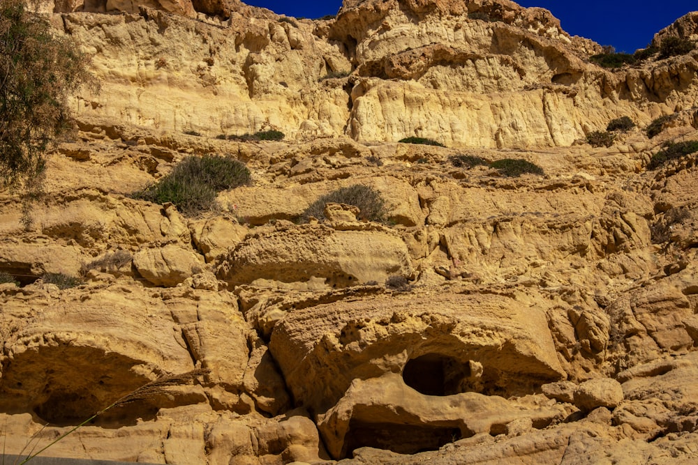 a rocky cliff with a hole in the middle of it