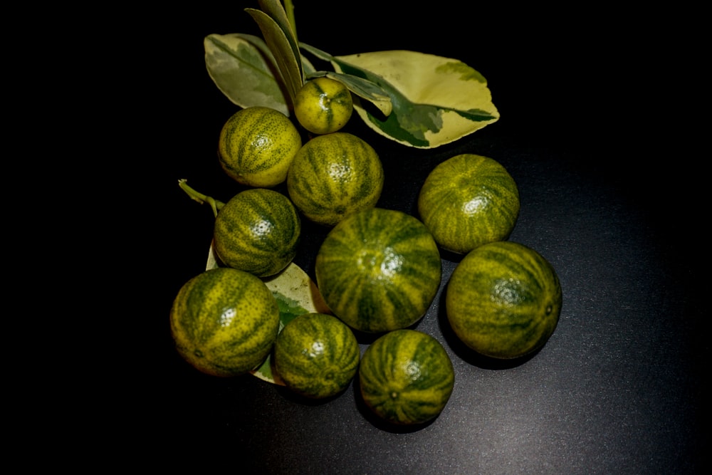 a bunch of green fruit sitting on top of a table
