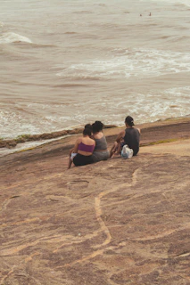A group of travelers sitting peacefully by the shore, sharing a moment of connection and relaxation.