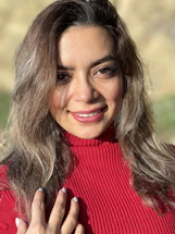 A warm photo of a volunteer warmly greeting a community member outdoors.