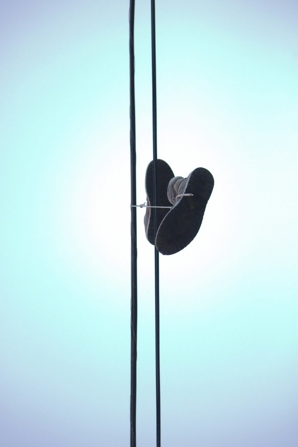 a pair of skis hanging from poles against a blue sky