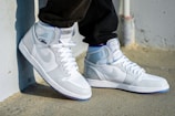 a pair of white sneakers with blue accents