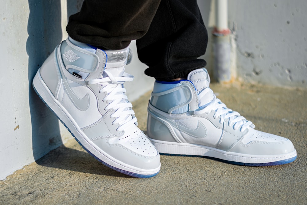 a pair of white sneakers with blue accents