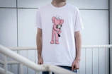 a man wearing a pink teddy bear t - shirt