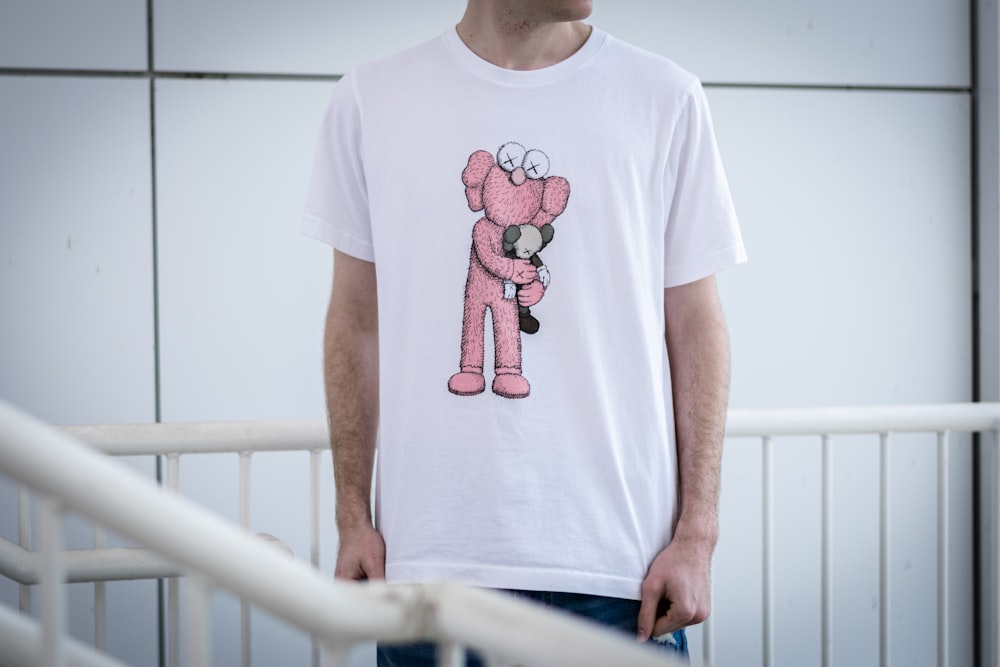 a man wearing a pink teddy bear t - shirt