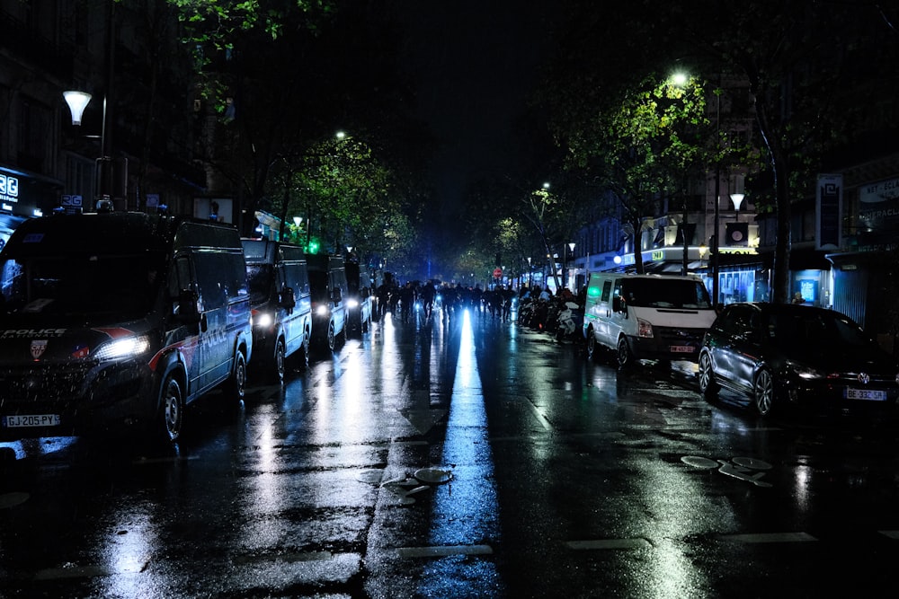 a group of people walking down a street at night