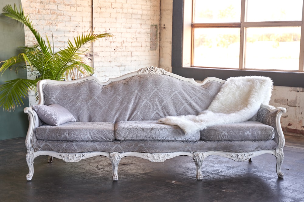 a couch sitting in a room next to a window