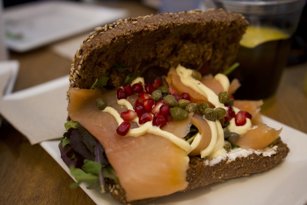 a sandwich with meat and vegetables on a plate