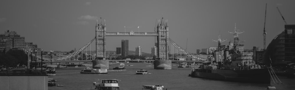 a black and white photo of boats in the water