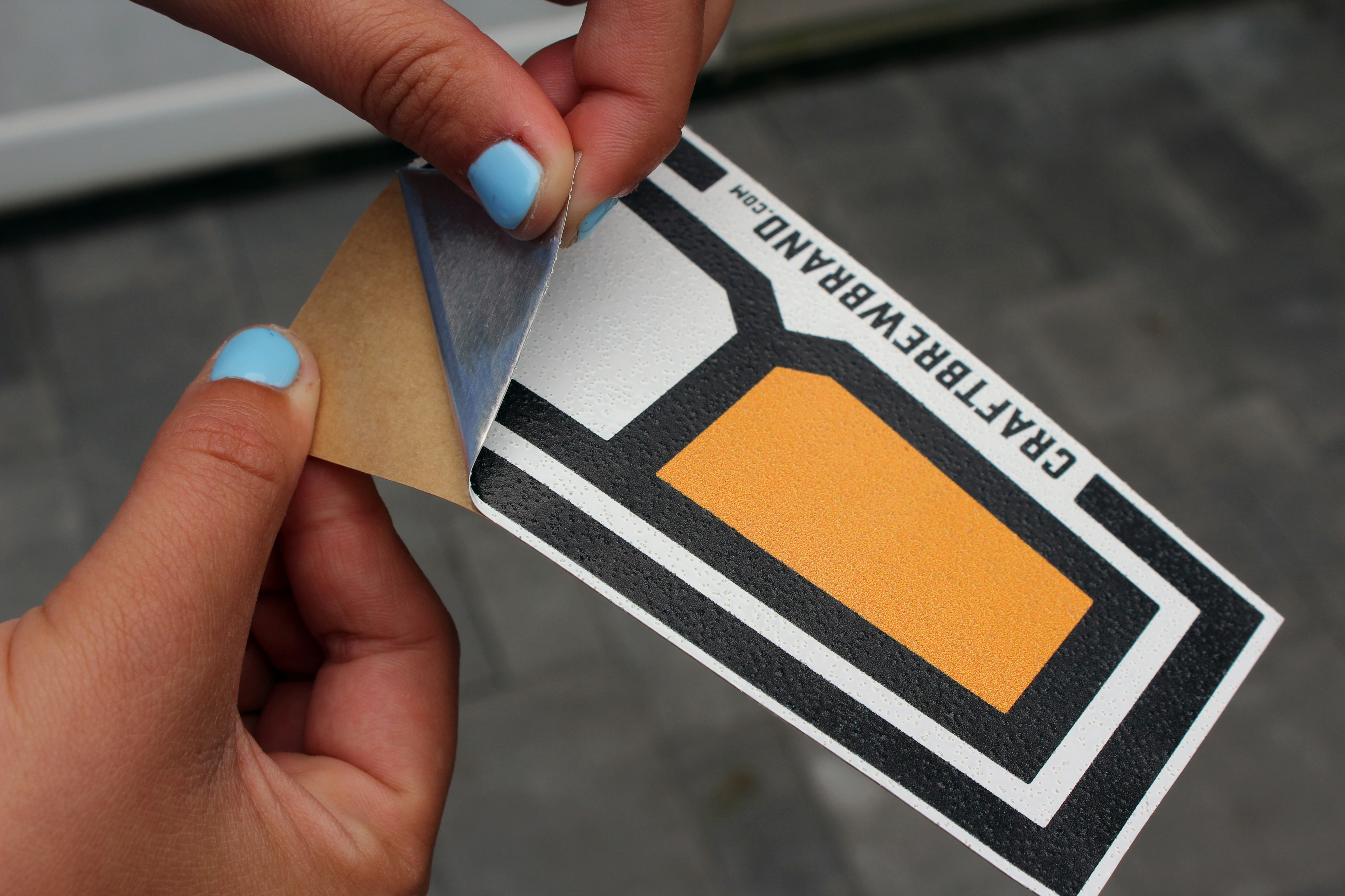 a person holding a business card with a piece of paper in their hand