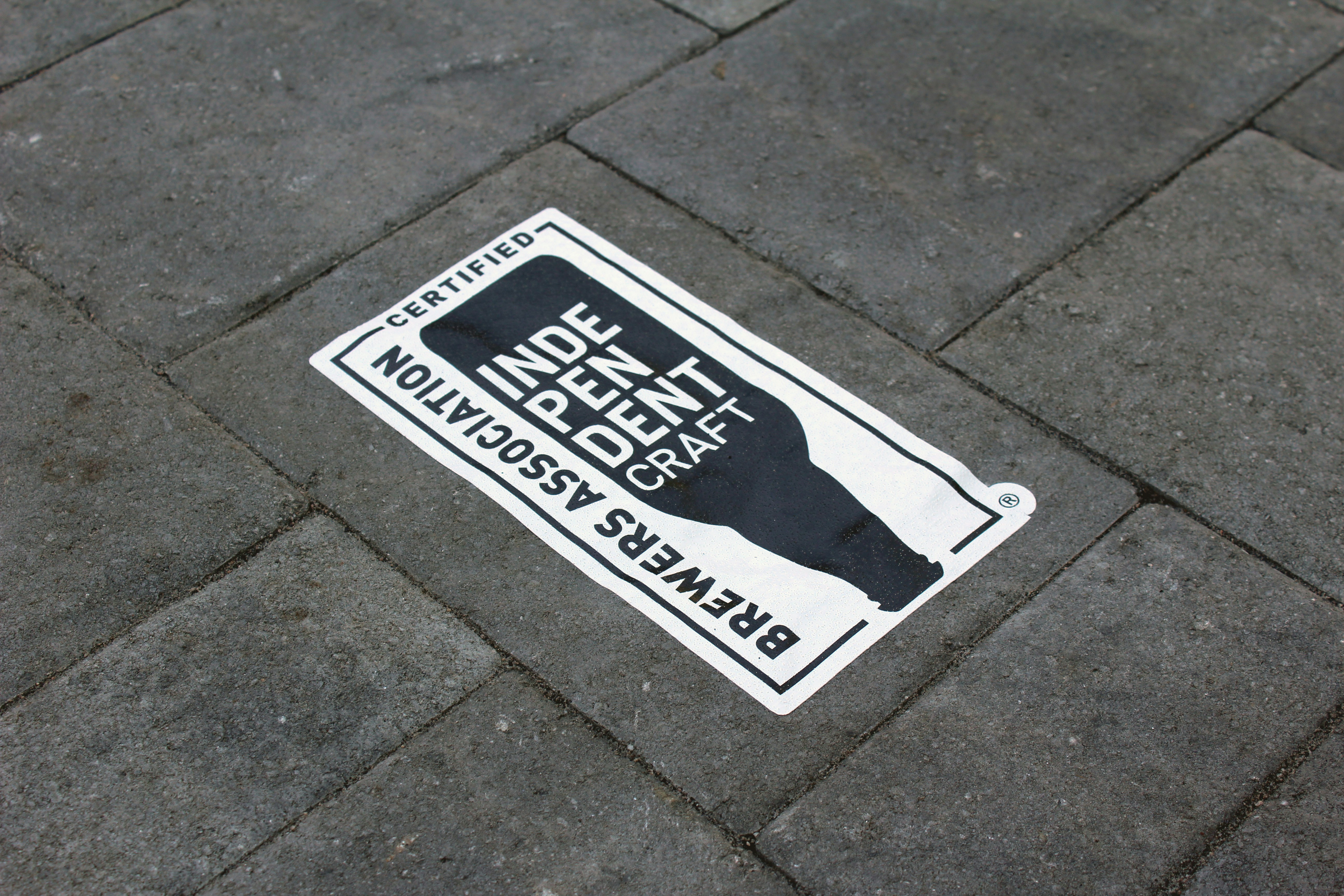 a street sign on the ground on a sidewalk