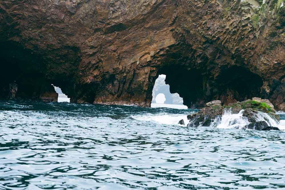 a cave with icebergs floating in the water