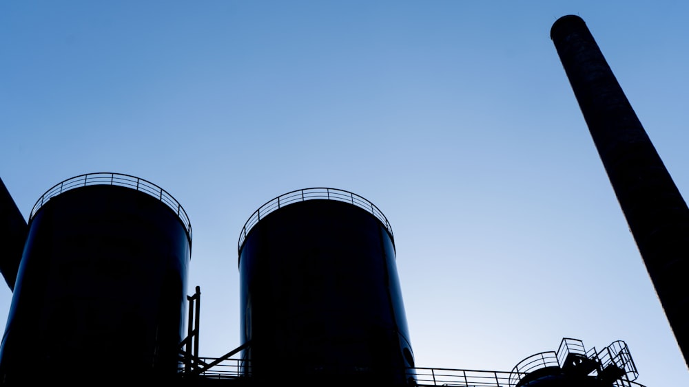 a silhouette of a factory building with smokestacks