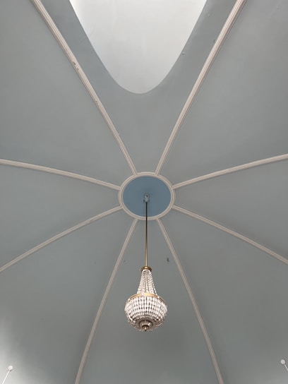 Elegant restaurant interior with warm lighting and artistic blue dome ceiling.