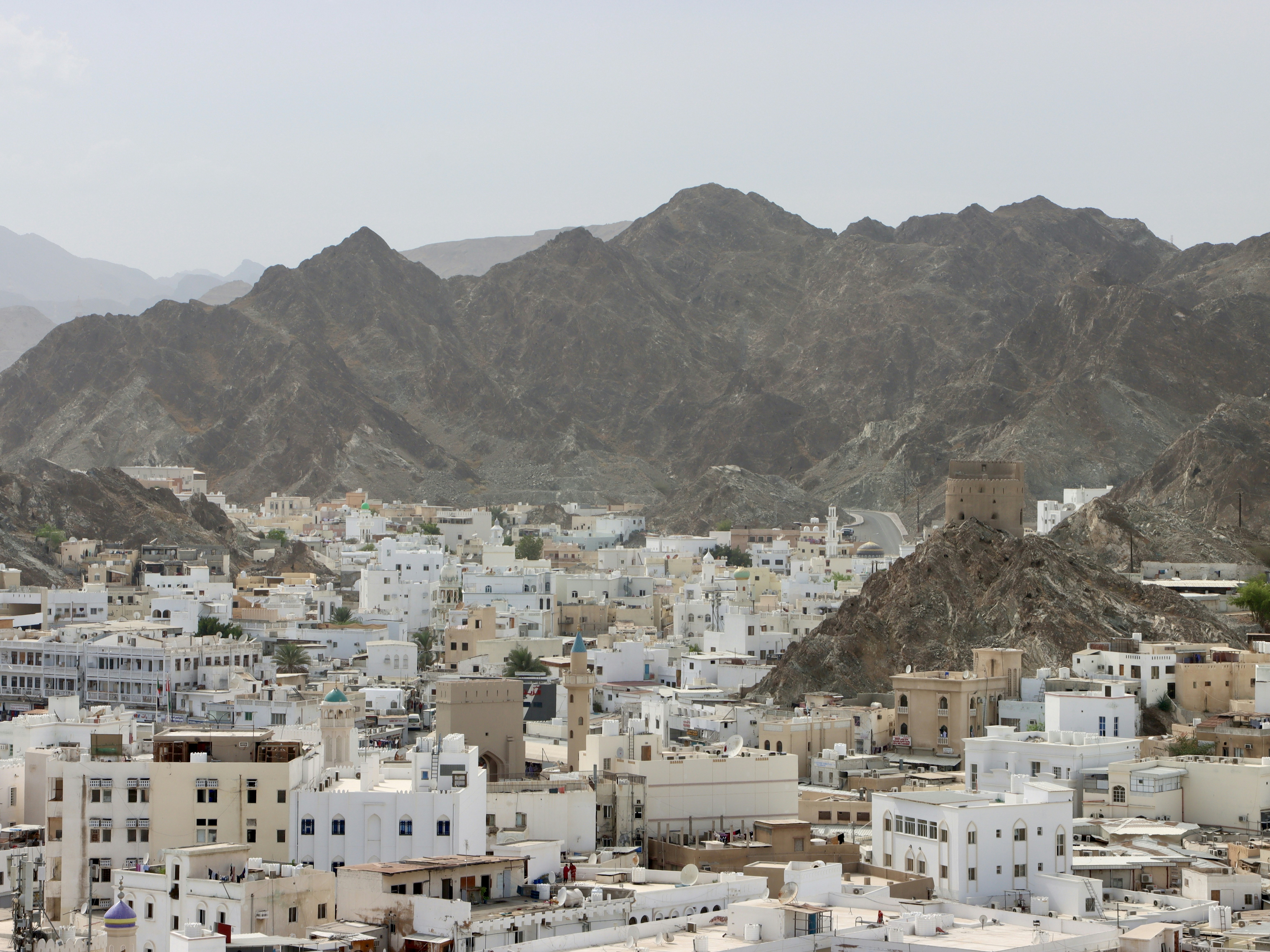 a view of a city with mountains in the background, Muscat🇴🇲