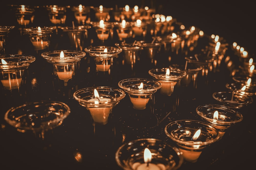 a group of lit candles sitting on top of a table