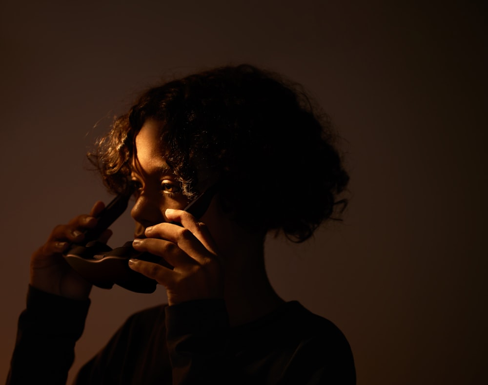 a woman talking on a cell phone in the dark