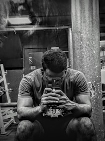 A fitness professional using a tablet to manage client bookings in a bright studio.