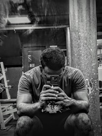 Person filling out a fitness goal questionnaire on a smartphone with blurred dark background.