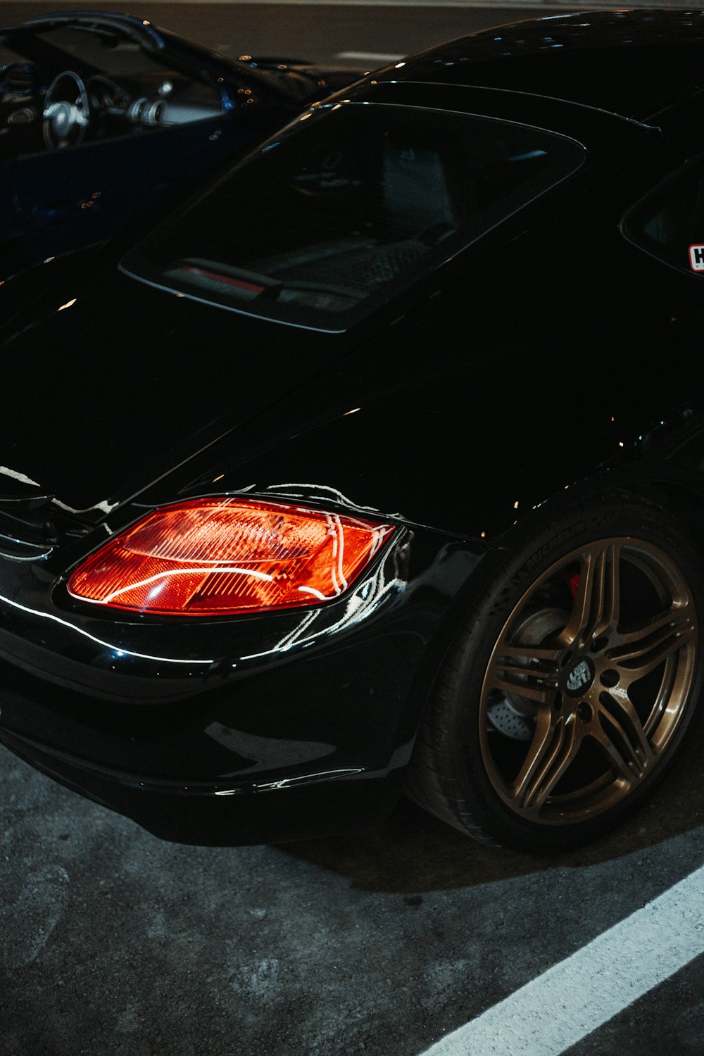 a black sports car parked in a parking lot