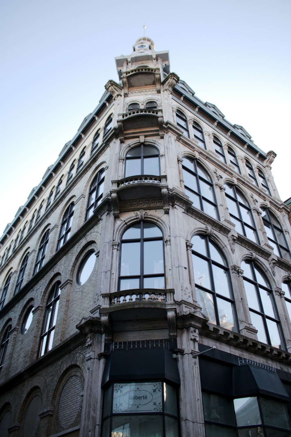 a tall building with lots of windows and a clock on the top of it