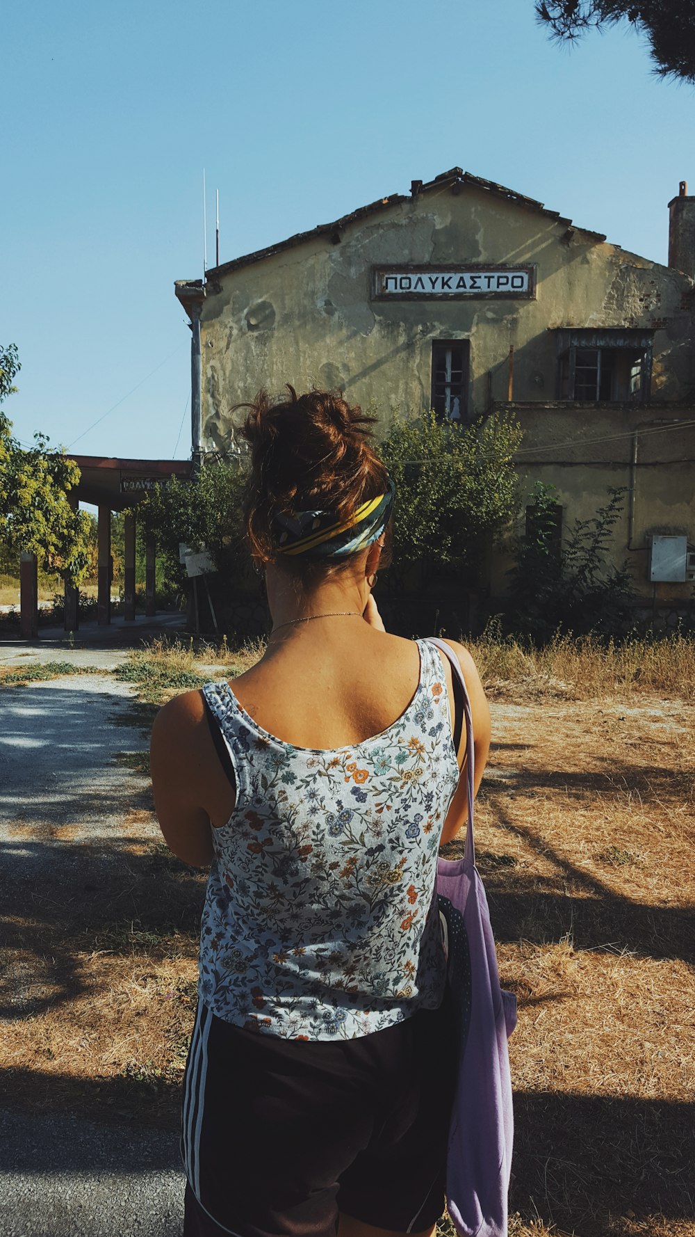 a woman with a headband standing in front of a building