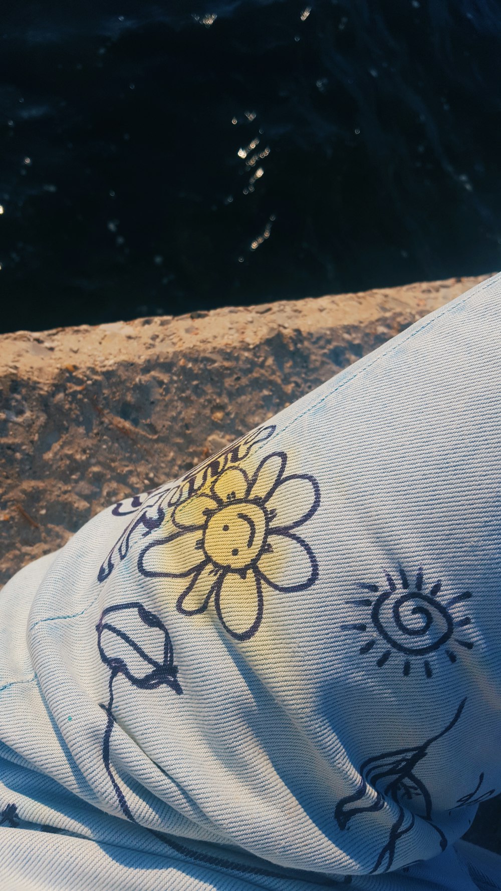 a close up of a person laying on a beach towel