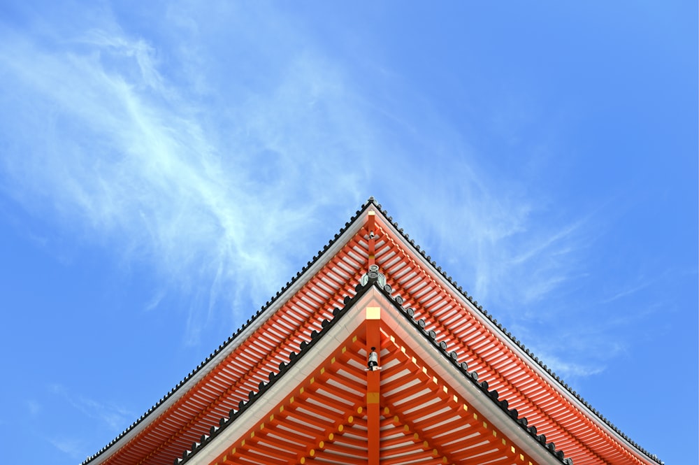 the roof of a building with a blue sky in the background