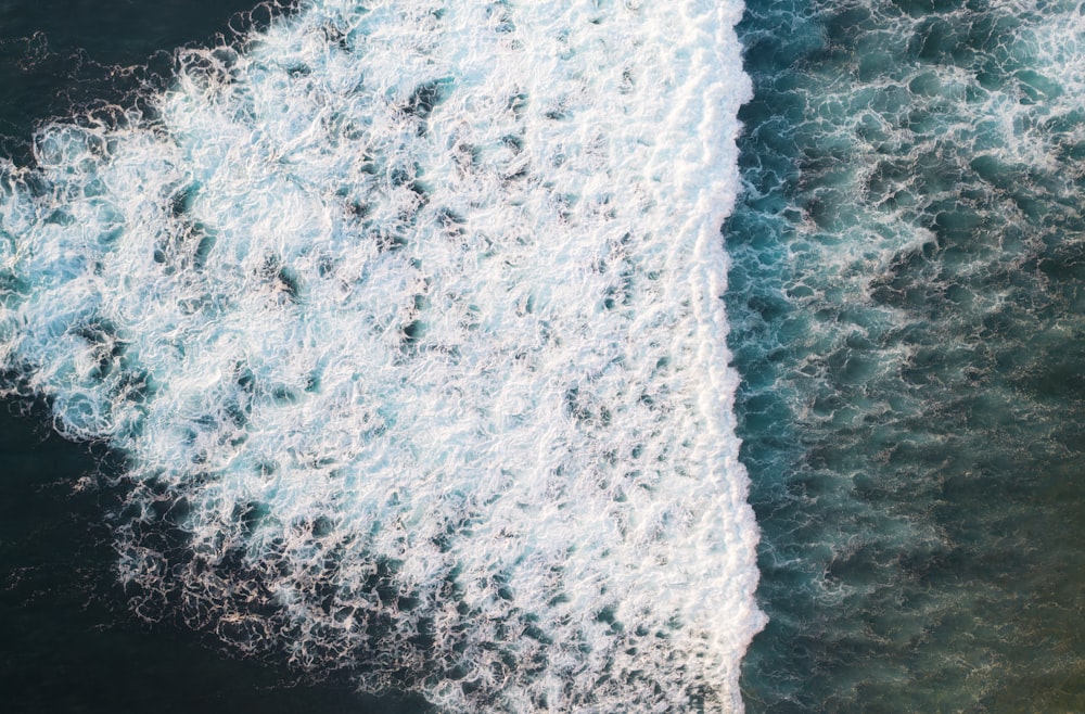 an aerial view of a surfer riding a wave