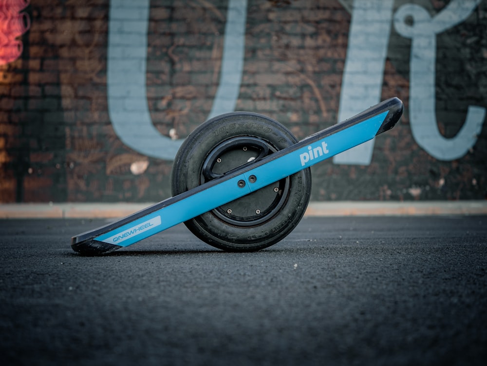 a skateboard laying on its side in front of a wall