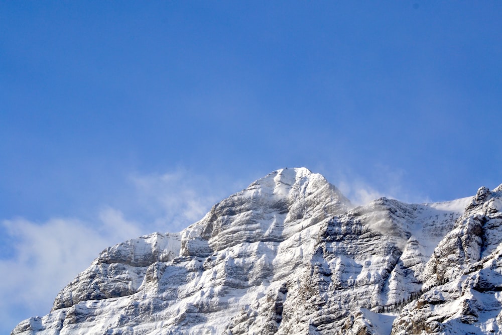 a mountain covered in snow under a blue sky