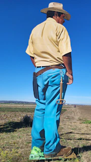 A worker wearing sturdy work pants and a tool belt, ready for a day on site.