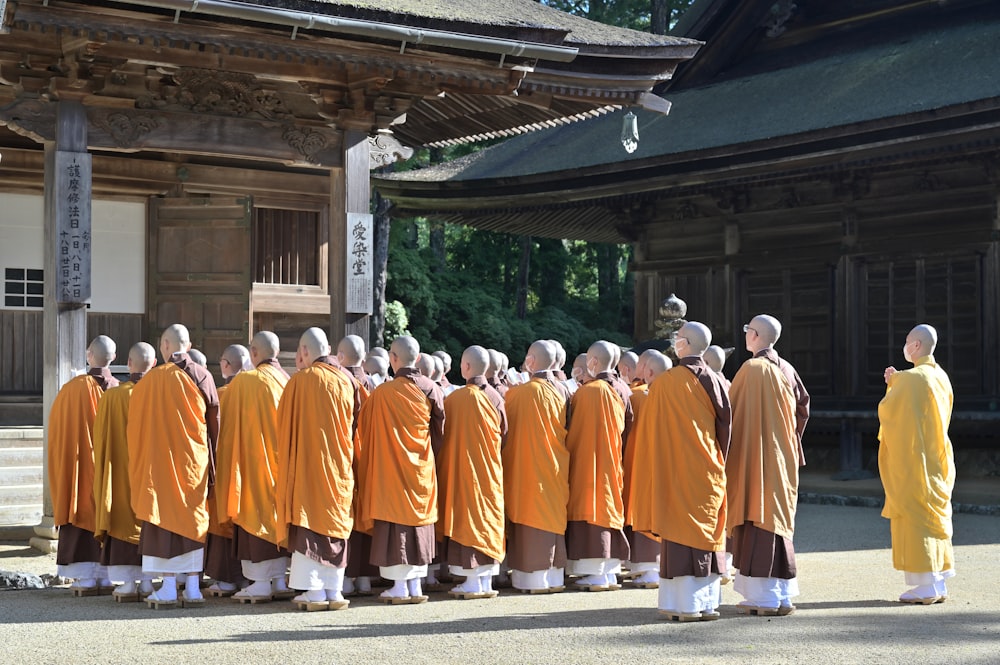 a group of monks standing in front of a building