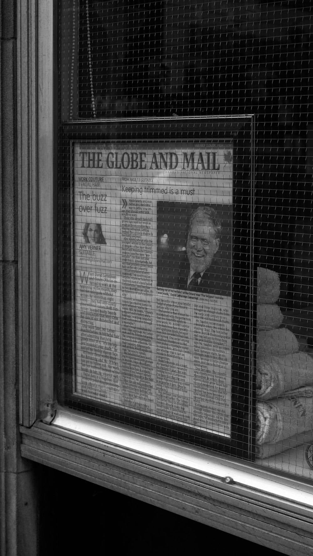 a newspaper on the window of a building