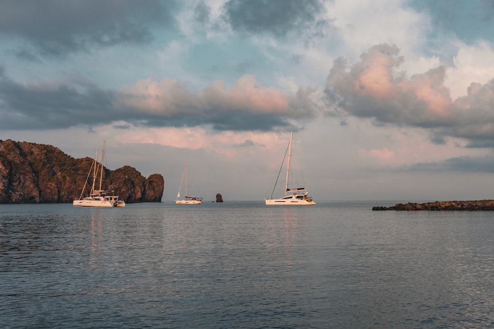 a couple of boats floating on top of a body of water