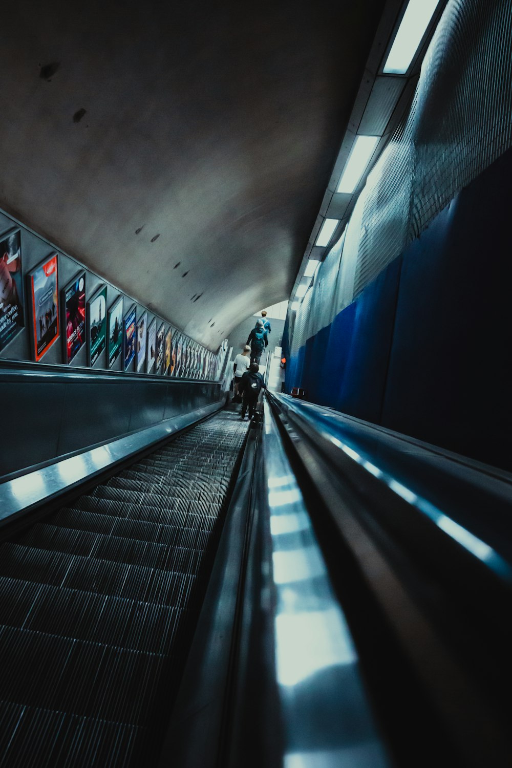 a person riding an escalator in a subway station