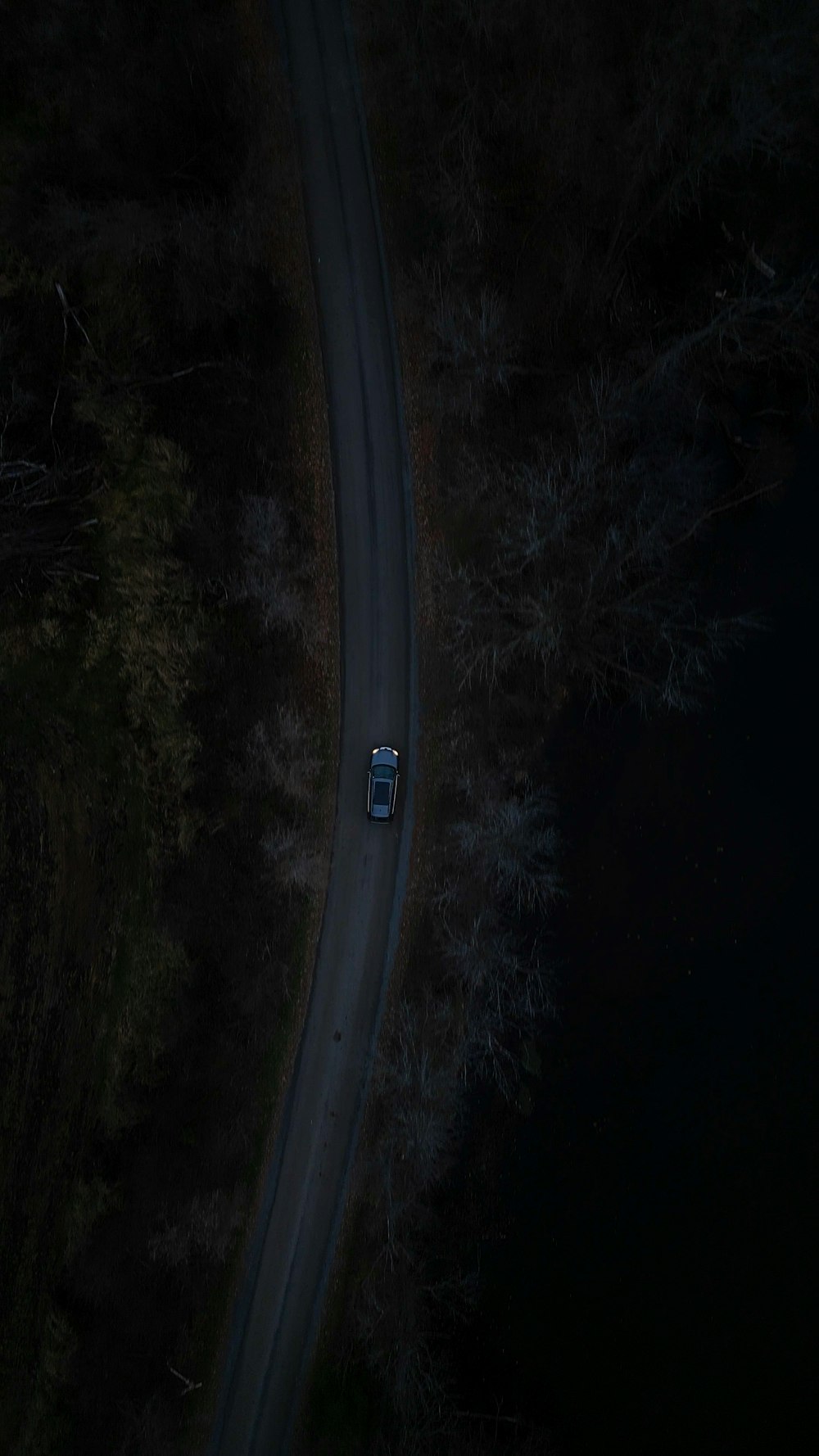 a car driving down a road at night