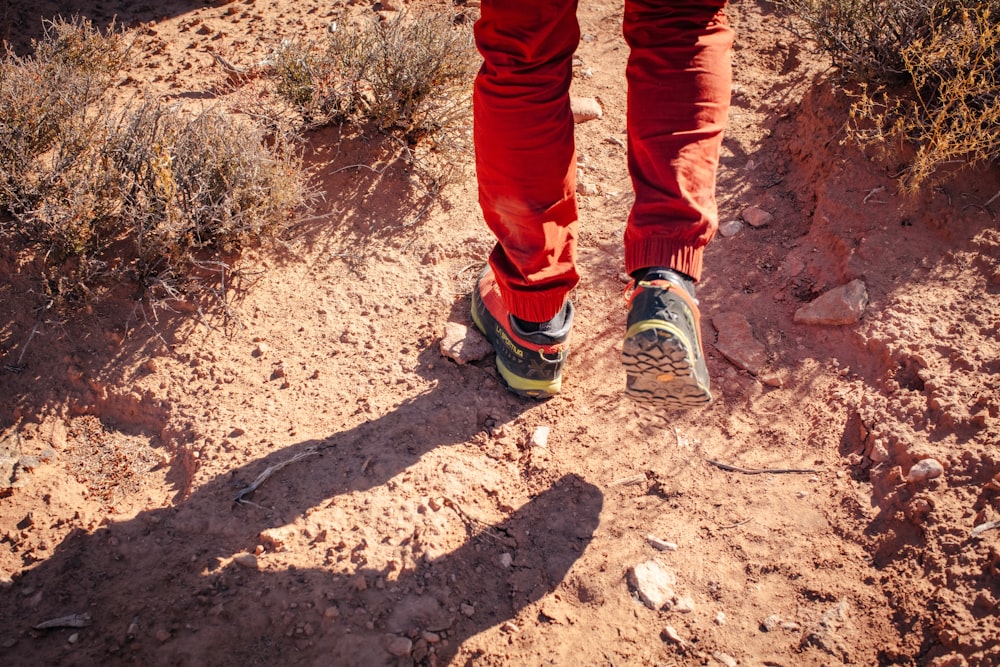 a person walking on a trail in the desert
