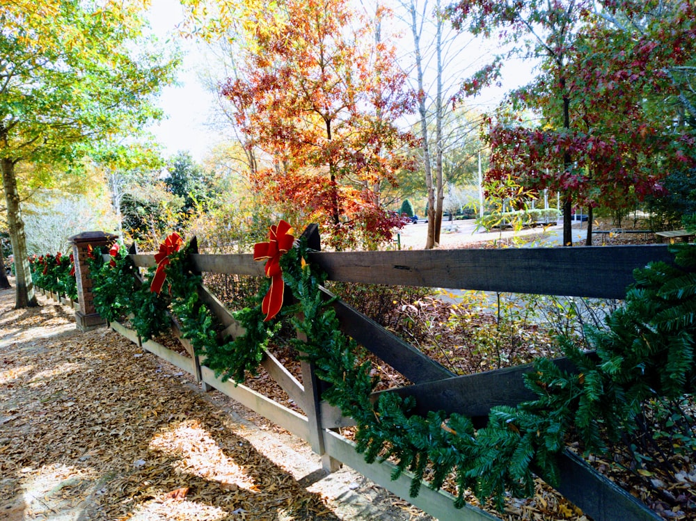 a wooden fence with christmas wreaths on it