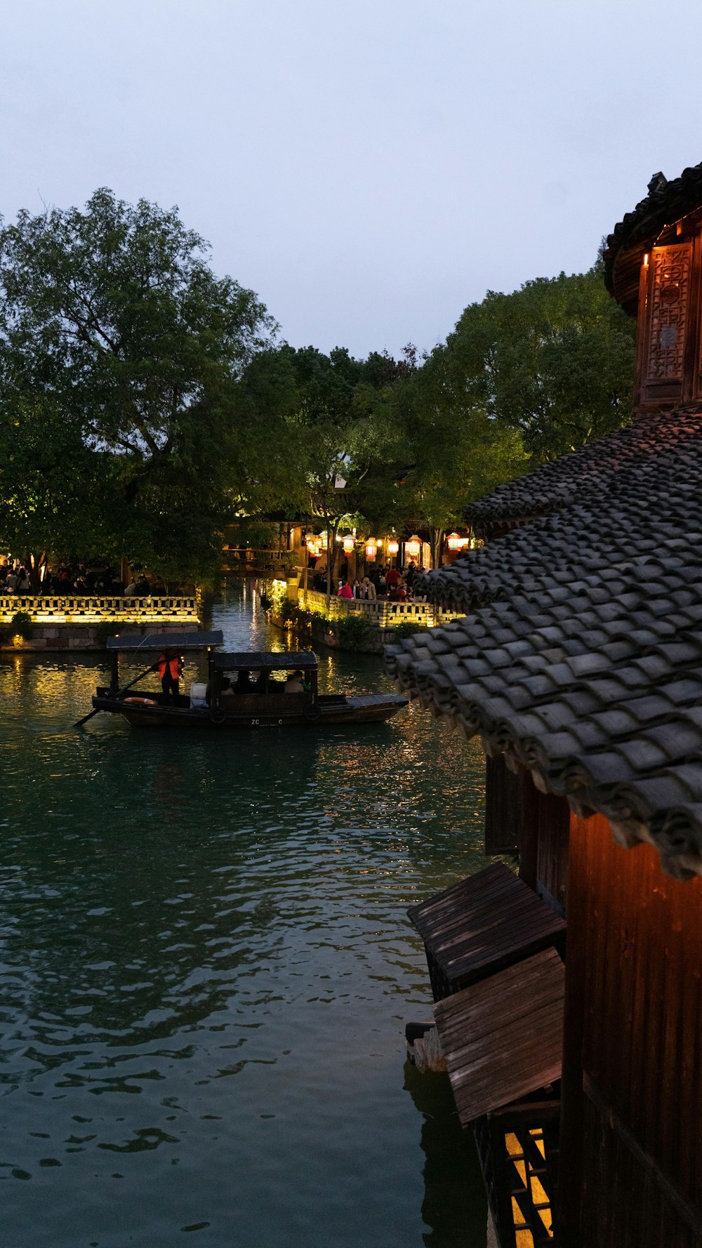 a boat floating on top of a lake next to a building