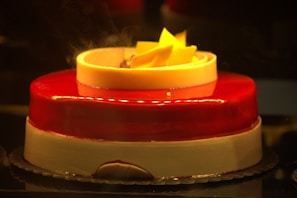 A custom cake decorated with fresh flowers and smooth chocolate glaze