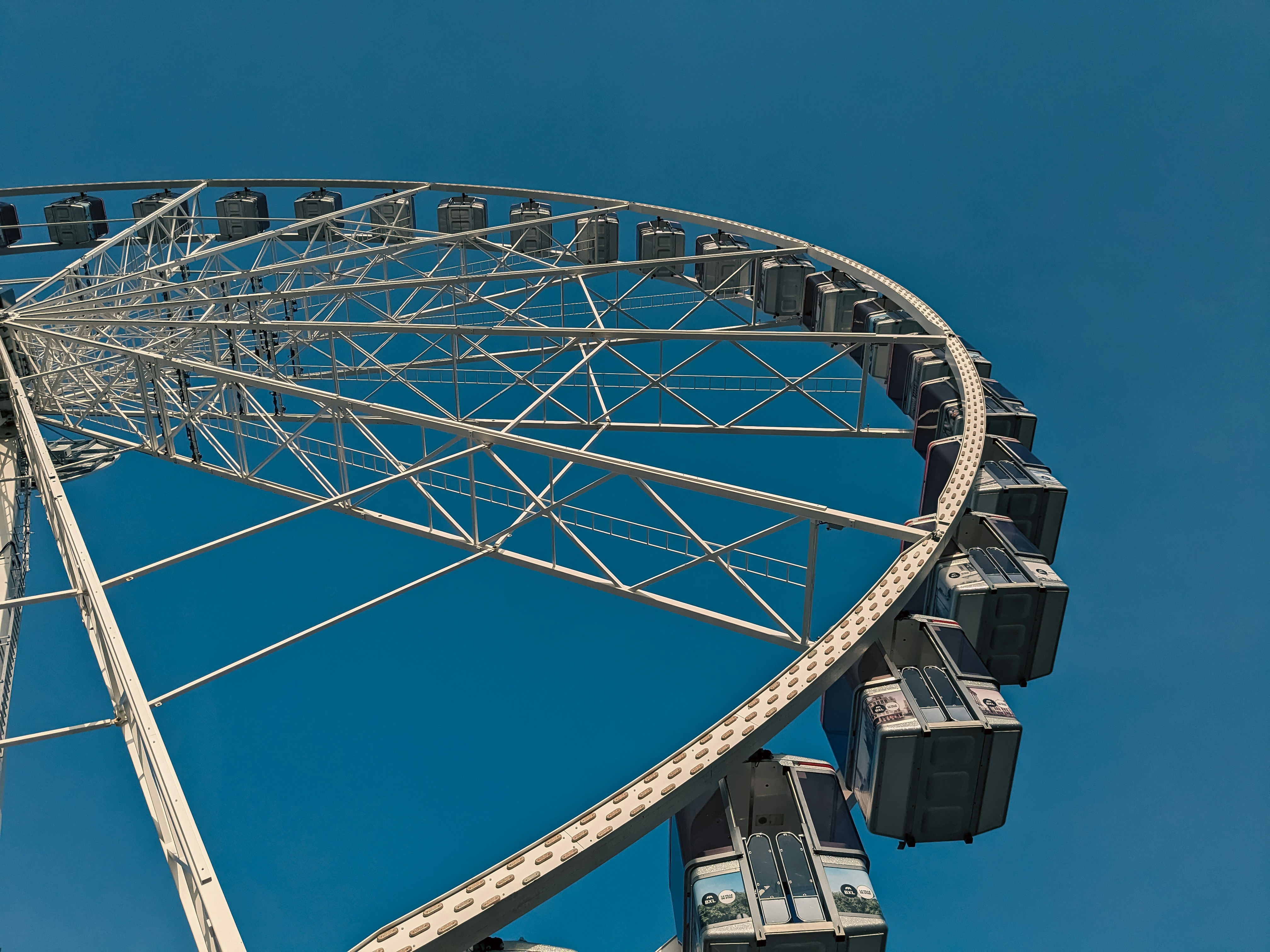 a ferris wheel against a clear blue sky