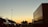 Freight trucks lined up on a highway ready for transport operations at sunset.