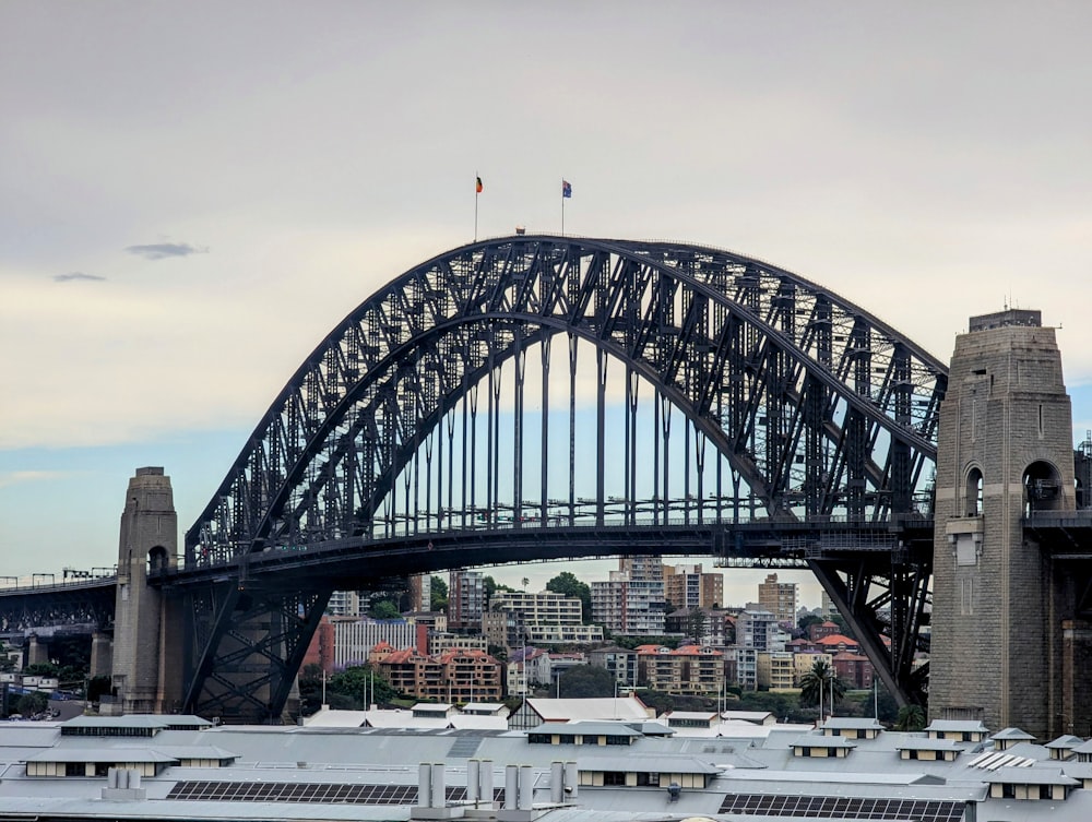 a large bridge spanning over a city with tall buildings