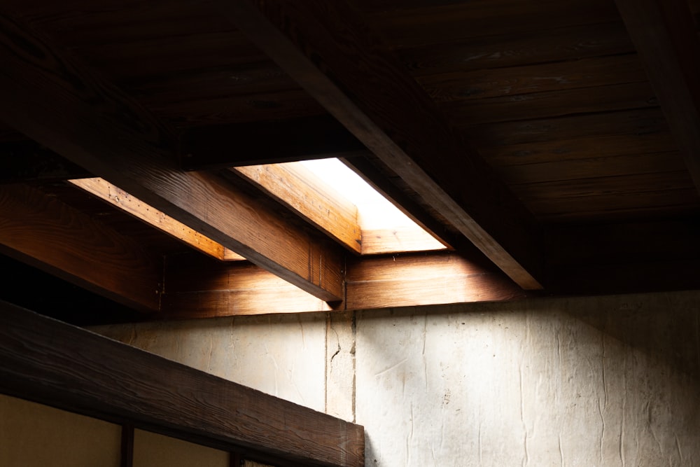 a room with a wooden ceiling and a window