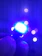 Close-up of a sleek LED underwater light glowing blue beneath a yacht at night.