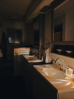 a bathroom with two sinks and a mirror