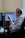 a man sitting in front of two computer monitors